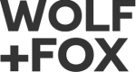 Black text on a white background reads "WOLF + FOX" in bold, uppercase letters, arranged in two lines.